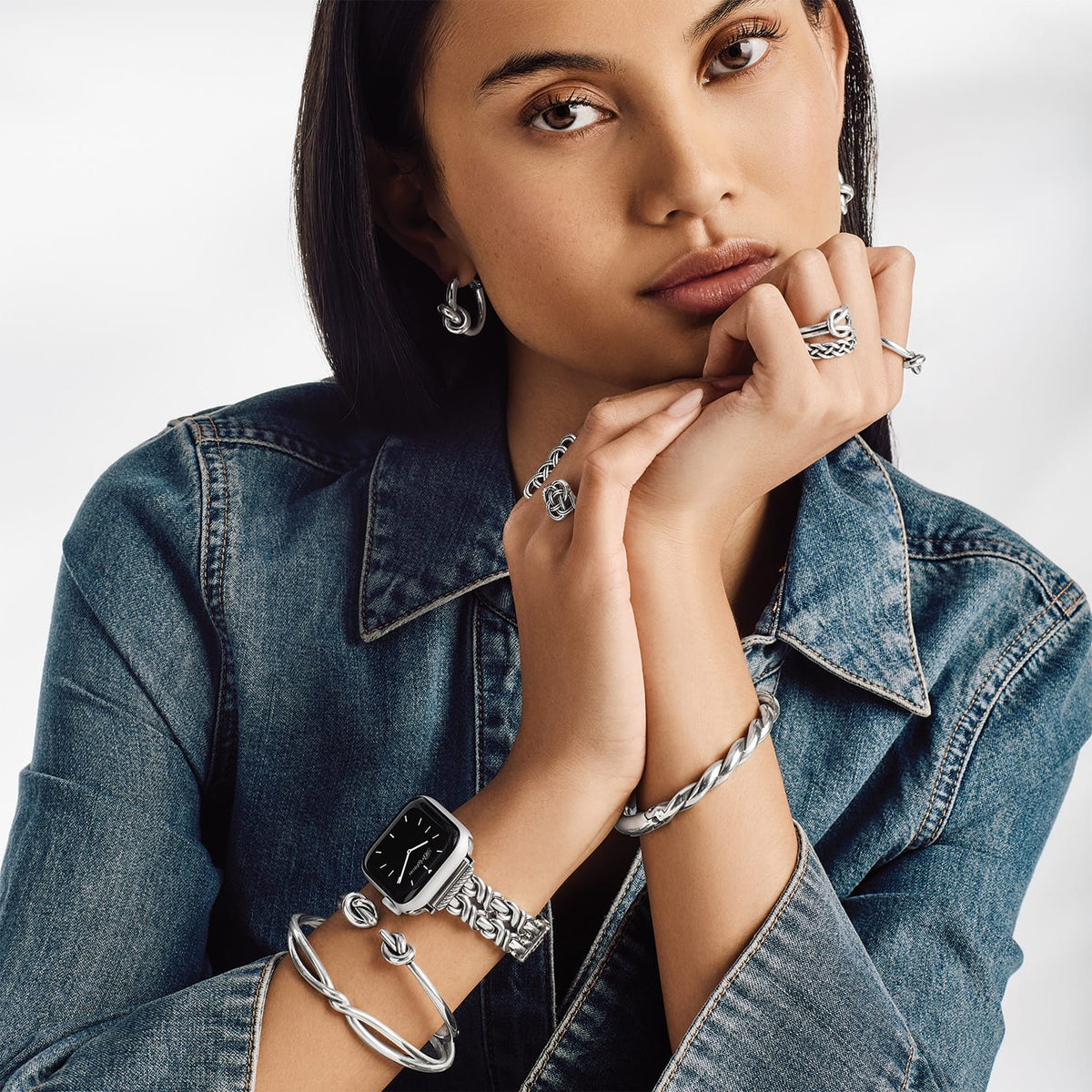 Model wearing a Brighton silver-plated watch with decorative bracelet band and coordinating Brighton accessories including rings and bangles