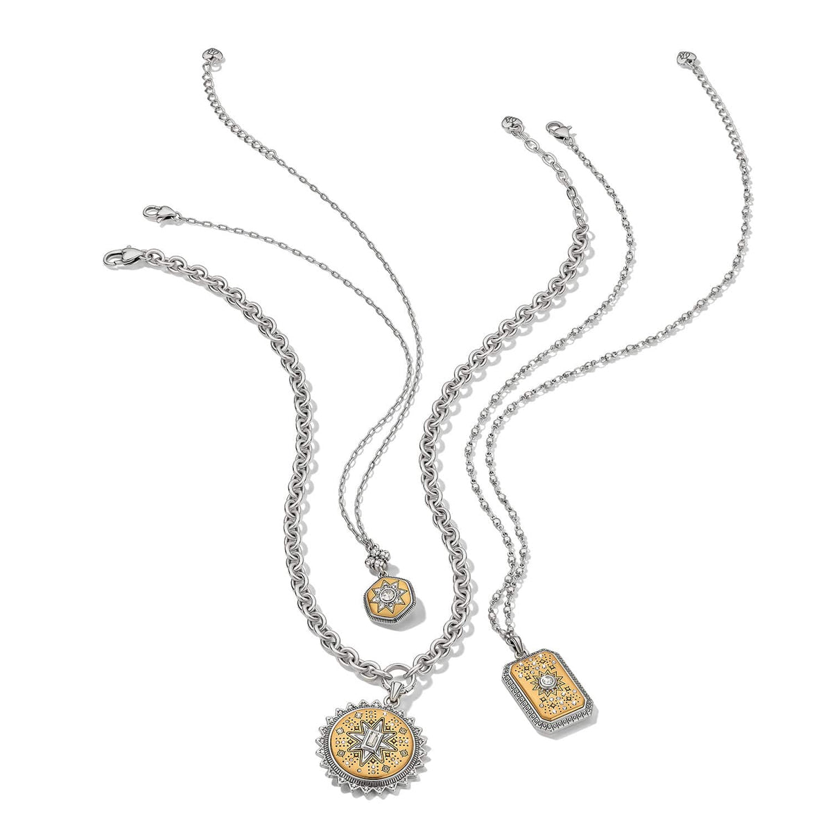 Brighton two-tone necklaces with gold star medallion pendants and crystal accents on silver chains on a white background