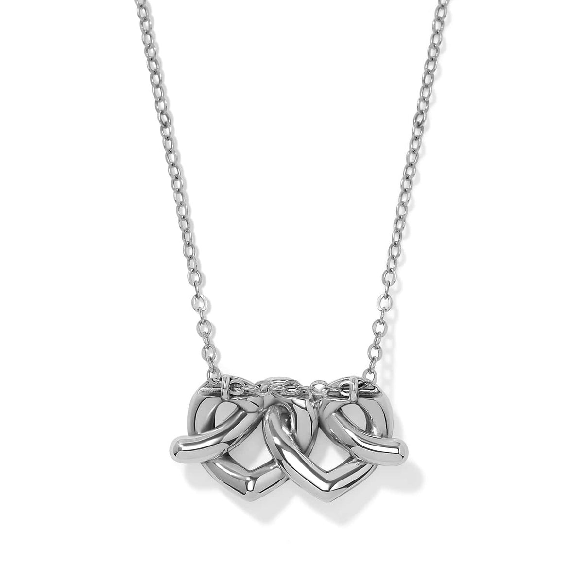 Brighton pendant necklace with three interlocking silver-plated heart charms on a delicate chain on a white background