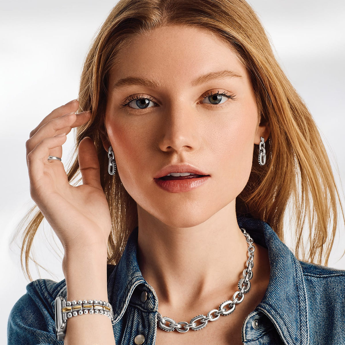 Model wearing Brighton silver-plated chain link necklace with coordinating hoop earrings and beaded bracelets